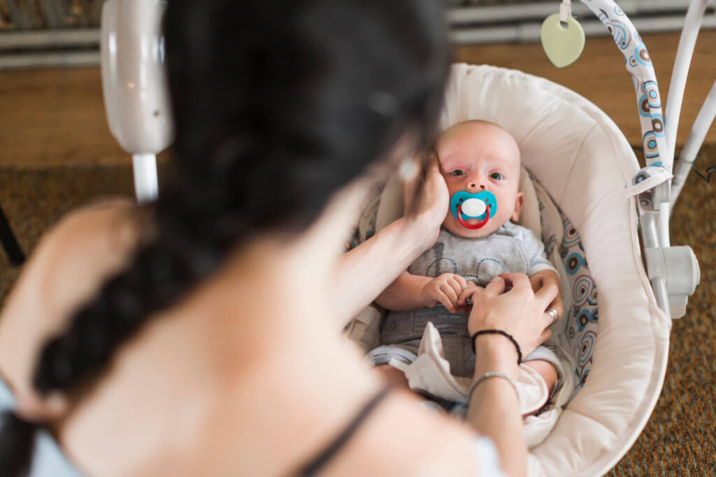 maman avec son bébé dans sa balancelle